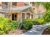 Inviting entrance with manicured landscaping and a charming covered walkway to the building's entrance at 5238 Manorwood Dr # 3C, Sarasota, FL 34235