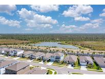 Aerial view of a home with a lake view, backing up to natural Florida preserve at 5715 Woodland Sage Dr, Sarasota, FL 34238