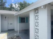 Charming home exterior showing covered parking, front door, and decorative brickwork at 6072 Arlene Way # 6072, Bradenton, FL 34207