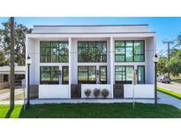 Modern townhome showcasing sleek architecture, large windows, and inviting private entrances at 941 N Osprey Ave, Sarasota, FL 34236