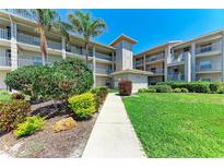 Condo exterior features well maintained landscaping and a sidewalk leading to the entrance at 9620 Club South Cir # 5208, Sarasota, FL 34238