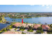 Aerial view of community homes with lake, bridge, and pool amenities; prime real estate location at 13724 Quinta St, Venice, FL 34293