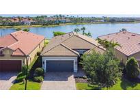 Stunning exterior shot showcases a well-manicured lawn and a charming one-story home with a tile roof at 13724 Quinta St, Venice, FL 34293