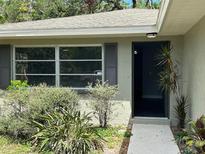 Landscaped front entrance featuring a modern front door, window, and tasteful plantings at 1461 17Th St, Sarasota, FL 34234