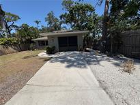 Charming one-story home with a well-maintained lawn and a screened two-car garage, offering curb appeal at 1461 17Th St, Sarasota, FL 34234