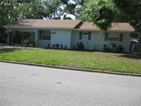 Charming single-story home with light blue exterior, brown roof, and well-maintained front yard at 1805 9Th W St, Palmetto, FL 34221