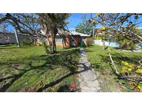 Charming single-story home with a well-maintained lawn and a quaint walkway leading to the front door at 2206 Avenue B, Bradenton Beach, FL 34217