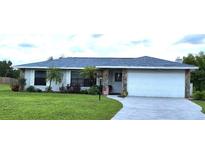 Charming single-story home featuring a well-manicured lawn and attached two car garage at 22116 26Th E Ave, Bradenton, FL 34211