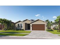 Charming single-story home featuring a two-car garage, well-kept lawn, and tropical landscaping at 270 Hillshire Pl, Spring Hill, FL 34609