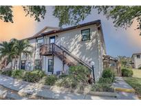 Charming condo exterior with well-maintained landscaping and stairway to the unit's entrance at 2825 74Th W St, Bradenton, FL 34209