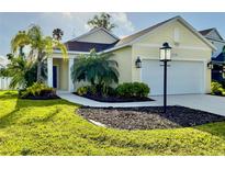 Charming one-story home featuring a well-manicured lawn and beautiful landscaping at 3706 Shimmering Oaks Dr, Parrish, FL 34219