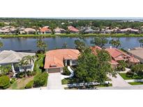 Charming single-story home boasts a new tile roof and is situated on a picturesque lakefront property at 4961 Sabal Lake Cir, Sarasota, FL 34238