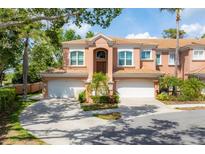 Two-story townhome featuring a two-car garage, and well-manicured front yard at 5405 46Th W Ct, Bradenton, FL 34210