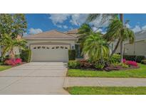 Charming single-story home with lush landscaping and a spacious two-car garage at 8263 Nice Way, Sarasota, FL 34238