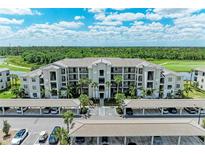 Stunning aerial view of a condo building with covered parking and lush landscaping at 18028 Gawthrop Dr # 203, Bradenton, FL 34211