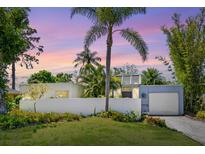 Charming single-story home with lush landscaping and a unique architectural design in a tropical setting at 2720 Herwald St, Sarasota, FL 34231