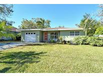 Charming single-story home with a well-maintained lawn, inviting curb appeal, and mature landscaping at 314 28Th W St, Bradenton, FL 34205
