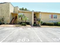 Inviting condo exterior with well-maintained landscaping and assigned parking spaces at 3403 Clark Rd # 203, Sarasota, FL 34231