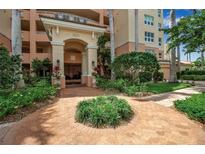 Beautiful building entrance with brick walkway and lush landscaping at 3621 North Point Rd # 603, Osprey, FL 34229