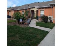 Inviting front exterior with well-manicured lawn and charming patio seating area at 4707 1St E Ave # 4707, Palmetto, FL 34221