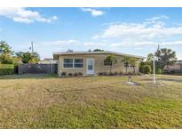 Charming tan home with well-manicured lawn and mature landscaping, offering great curb appeal at 516 45Th Street W Ct, Palmetto, FL 34221