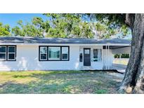 Charming single-story home with a carport, white siding, and black trim around the windows at 1028 36Th E Ave, Ellenton, FL 34222
