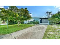 Charming single-story home with well-maintained lawn, mature trees and a long concrete driveway at 4015 52Nd Street W Ct, Bradenton, FL 34209