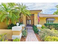 Charming home exterior with lush landscaping, a brick walkway and a welcoming entrance at 919 80Th Nw St, Bradenton, FL 34209