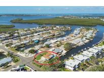 Stunning aerial view of waterfront homes with private docks and lush landscaping in a coastal community, Tampa Bay, Florida at 10304 Sandpiper W Rd, Bradenton, FL 34209