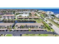 An aerial view of waterfront condominiums with boat docks and a canal leading to the water at 245 Coldeway Dr # B10, Punta Gorda, FL 33950