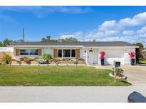 Charming single-story home with landscaped yard, brick planters, and attached one car garage at 309 Glen Oak Rd, Venice, FL 34293