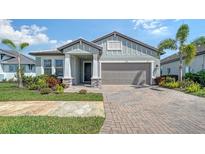 Charming home with a brick driveway, two-car garage, and lush landscaping for added curb appeal at 4725 Antrim Dr, Sarasota, FL 34240
