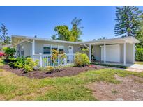 Charming single-story home with well-manicured lawn and covered porch at 5675 Saint Louis Ave, Sarasota, FL 34233