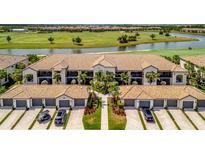 Stunning aerial view of the property with a beautiful golf course and lake in the backdrop at 5694 Palmer Cir # 202, Bradenton, FL 34211