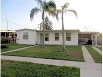 Charming single-story home with a well-maintained lawn and mature palm trees in the front yard at 6339 Pontiac Ln, North Port, FL 34287