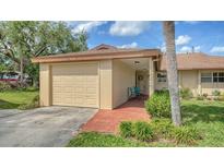Charming home with a one-car garage and inviting entrance, framed by lush landscaping at 7142 Bright Creek Dr # 35, Sarasota, FL 34231