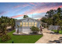 Charming single-story home with well-manicured lawn and inviting curb appeal at 8225 Drew St, Englewood, FL 34224