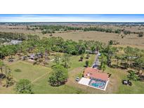 Expansive acreage estate featuring an inviting pool and fenced yard in a serene, private setting at 8280 Ibis St, Sarasota, FL 34241