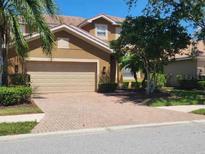 Beautiful two-story home featuring a large garage and well-maintained brick driveway at 9011 Hammock Edge Pl, Bradenton, FL 34212