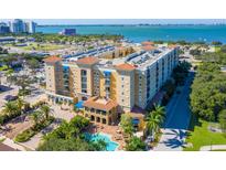 Beautiful condo complex featuring a large pool, lush landscaping and views of the bay at 1064 N Tamiami Trl # 1425, Sarasota, FL 34236