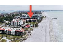 Beautiful aerial view of beachfront condos, pool and beach access on a sunny day at 1925 Gulf Of Mexico Dr # G8-307, Longboat Key, FL 34228