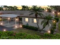 Charming single-story home with a carport and tropical landscaping in a tranquil setting at dusk at 2802 Swifton Dr # V102, Sarasota, FL 34231
