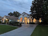 Charming one-story home featuring manicured landscaping and an inviting entrance illuminated by warm light at 3847 Little Country Rd, Parrish, FL 34219