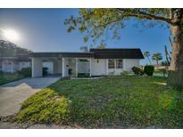 Charming single-story home with a lush green lawn and a convenient carport at 3904 Ashwood Ln, Sarasota, FL 34232