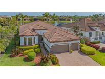 Beautiful Mediterranean home with a tile roof, two-car garage, and manicured landscaping at 5715 Inspiration Ter, Bradenton, FL 34210