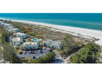 Aerial view of beachside condos featuring pool, parking, and easy access to the ocean at 6951 Gulf Of Mexico Dr # 14, Longboat Key, FL 34228