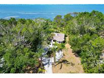 Stunning aerial view of lush landscaping surrounding waterfront home with a serene water view at 7620 Westmoreland Dr, Sarasota, FL 34243
