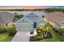 Charming single-Gathering home features a two-car garage, well-maintained landscaping, and a scenic lake view at 7743 Ridgelake Cir, Bradenton, FL 34203