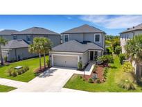 Well maintained two-story home featuring a two-car garage and manicured lawn at 8355 Velda Trl, Sarasota, FL 34241