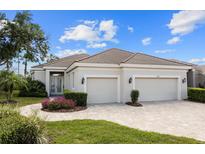 Charming single-story home with a tile roof, beautiful landscaping, and a two-car garage at 8630 51St E Ter, Bradenton, FL 34211